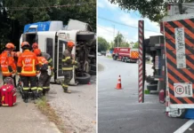 Carreta carregada com bobinas tomba em rotatória de acesso à Rodovia Fernão Dias